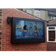Una caja para TV exterior 55" en una pared en el patio del pub